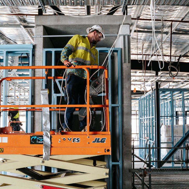 NRG Services team member on scissor life