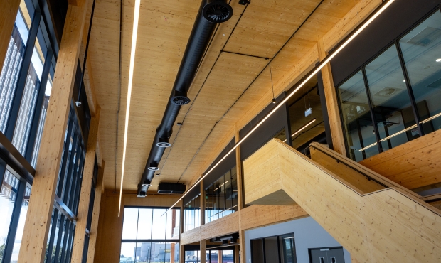 NRG Services delivering turn-key HVAC solutions, including DX air conditioning to office areas with exposed spiral ductwork, and smoke/general exhaust system and HVLS fans in the purpose-built warehouse.